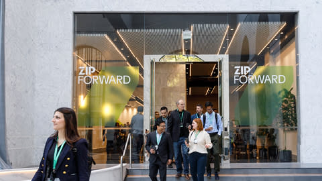 People standing by the entrance of Zip Forward conference 2023